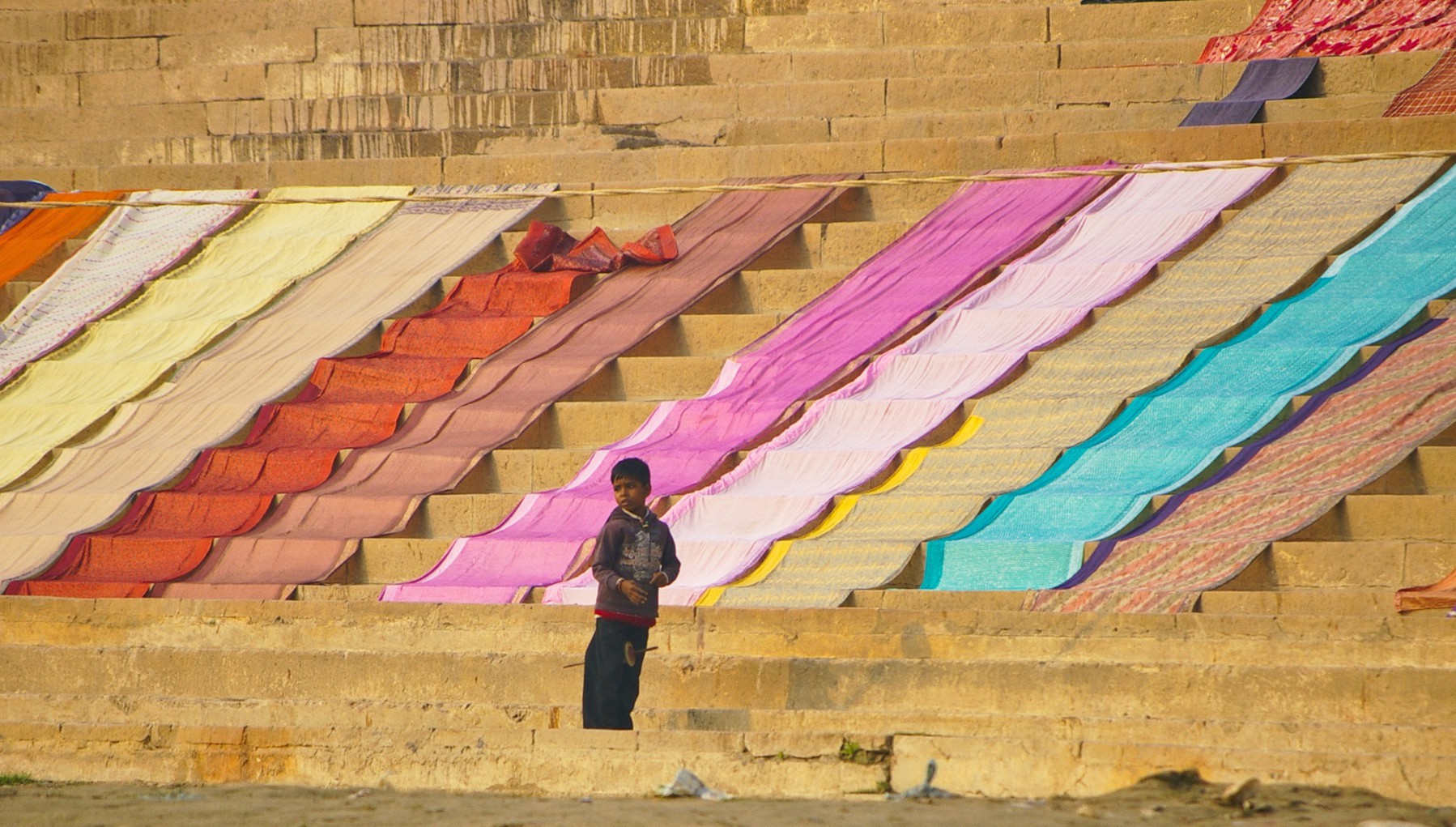 A boy flying kites on the banks of Ganga, Varanasi.